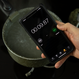 boiling water and stopwatch on phone